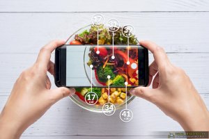 Calories Counting And Food Control Concept. Woman Using Application On Smartphone For Scanning The Amount Of Calories In The Food Before Eat